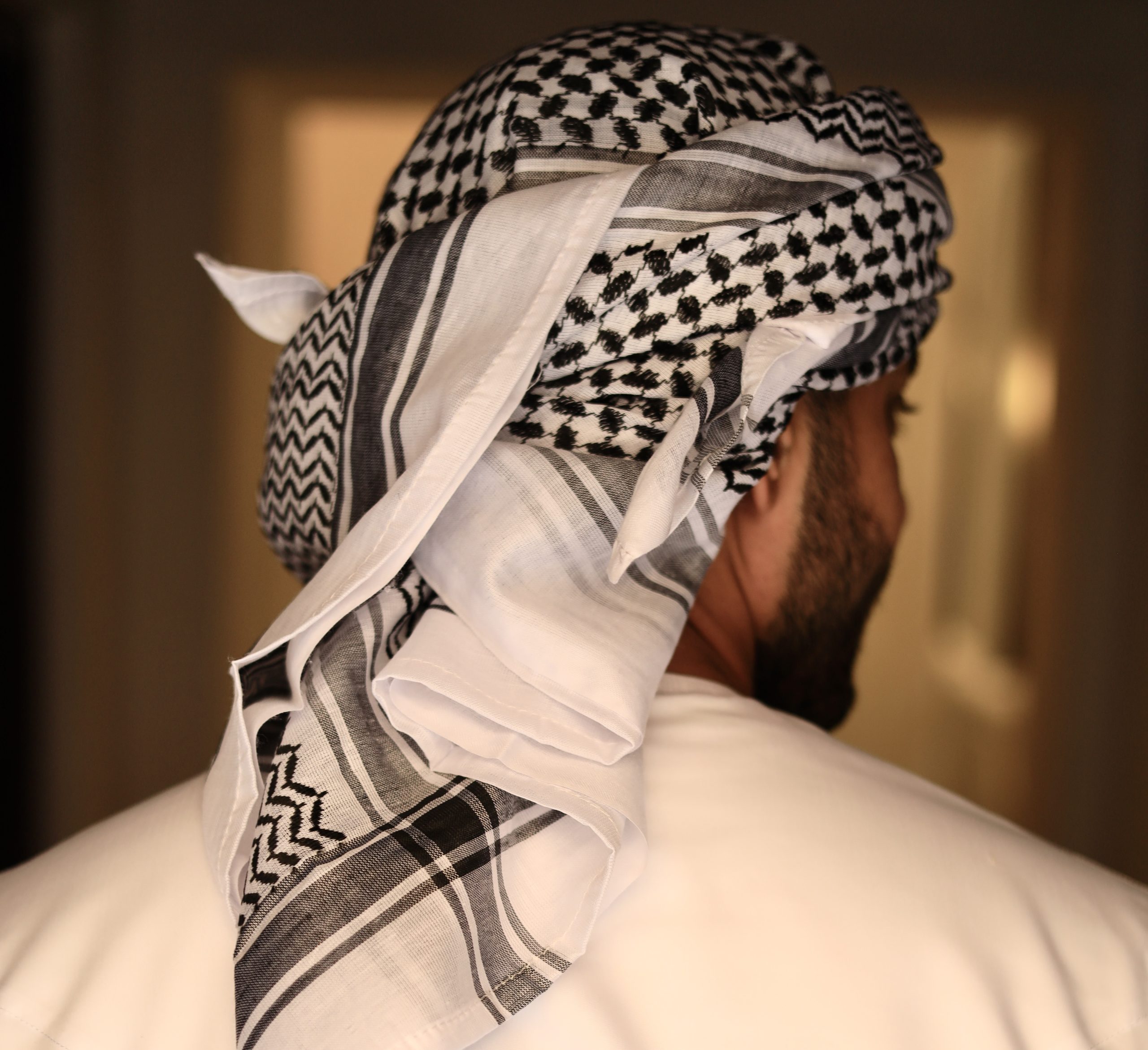 black and white keffiyeh scarf wrapped around the head