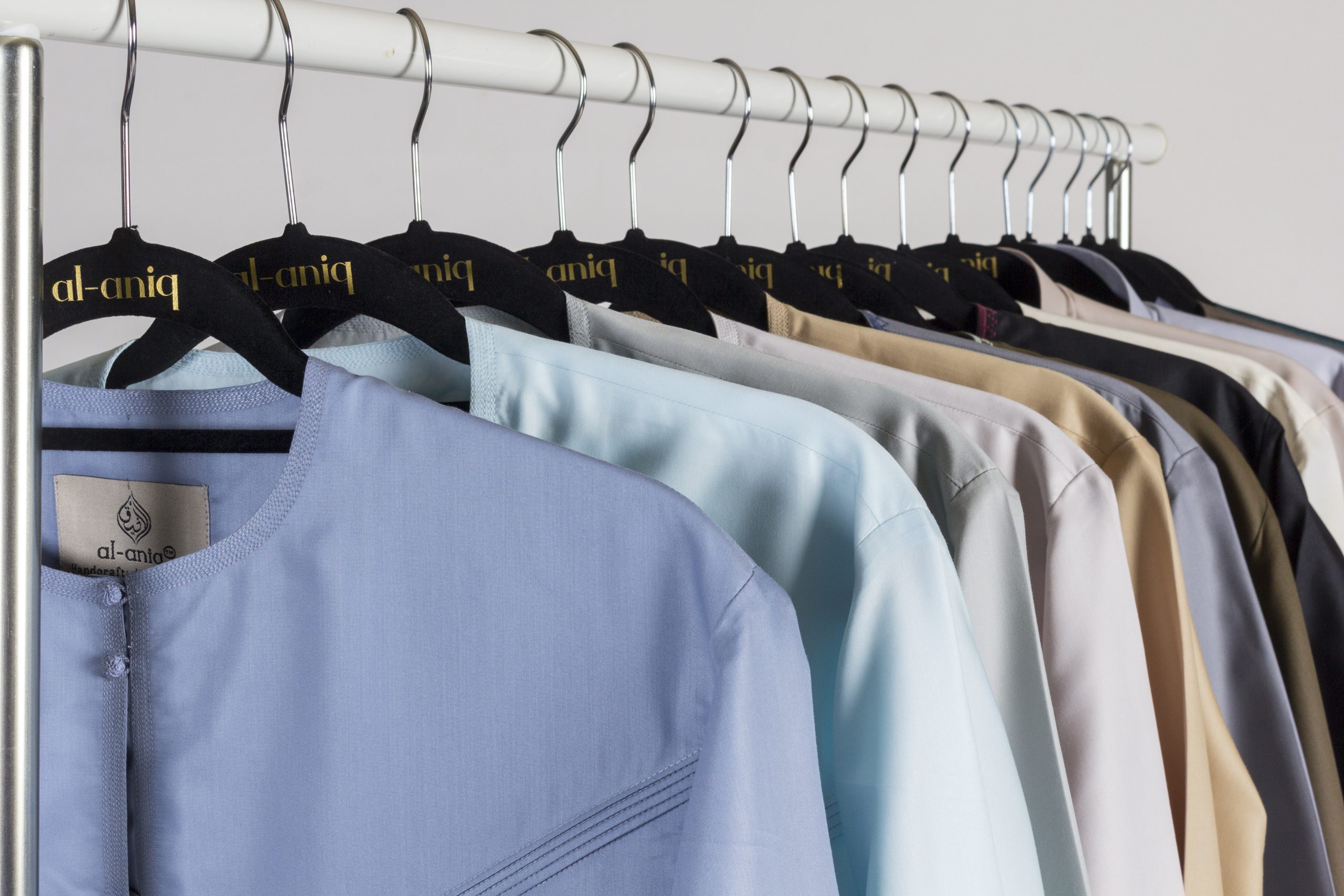 Rail of Al Aniq men's thobes in pastel and neutral colours