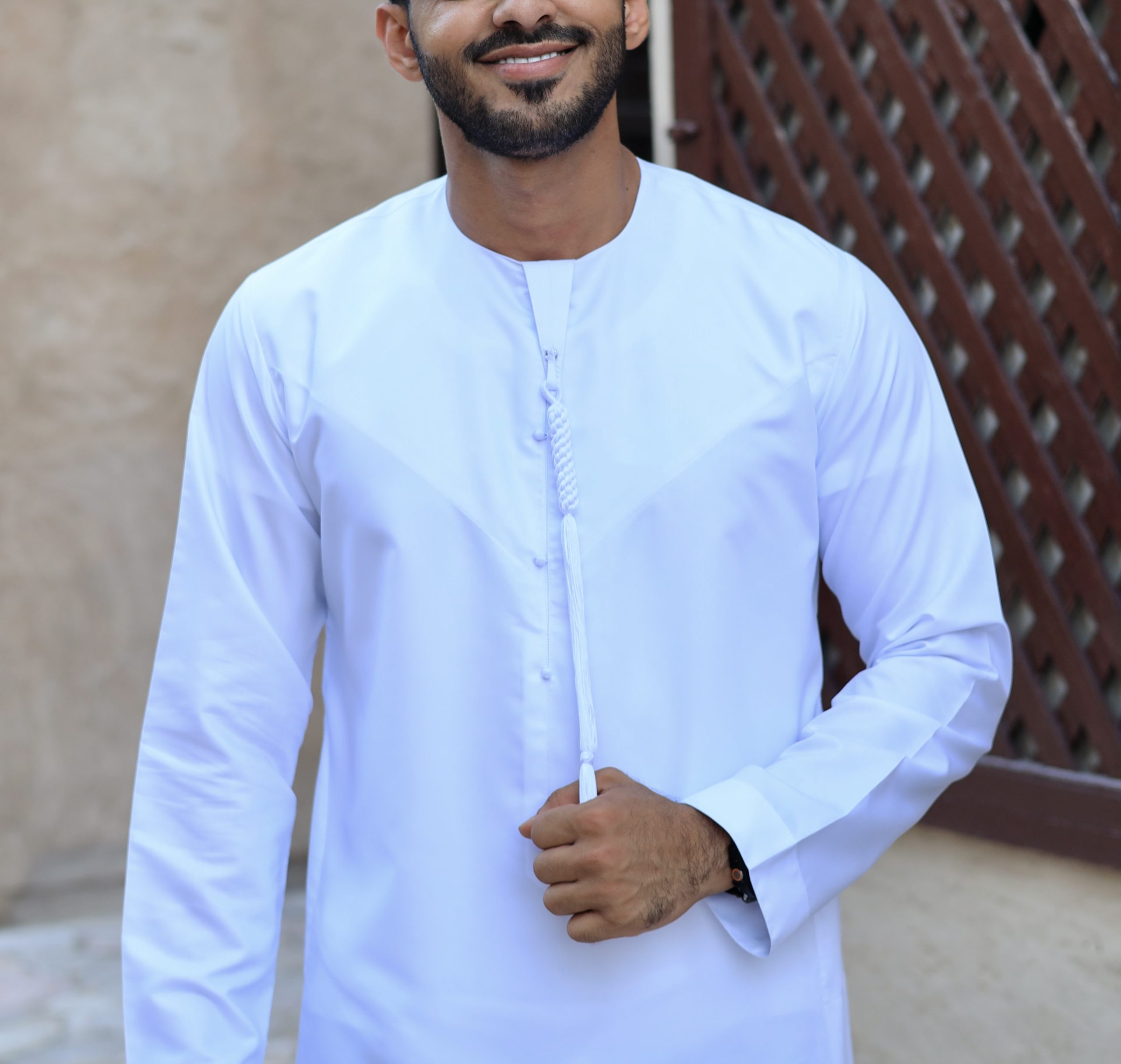 Model wearing a white Emirati thobe offering a classic and refined look for special events or everyday wear