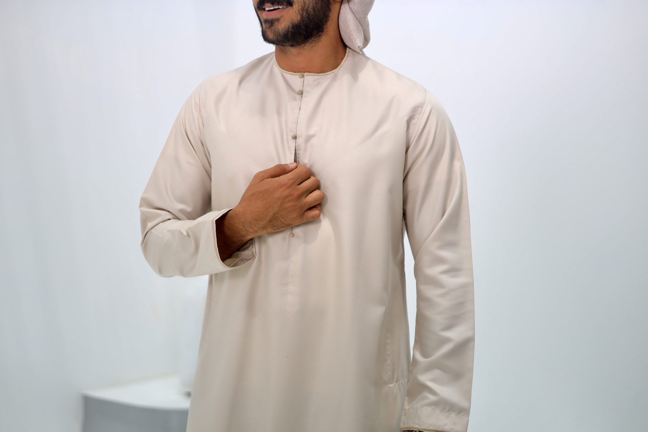 beige Emirati thobe with a tassel