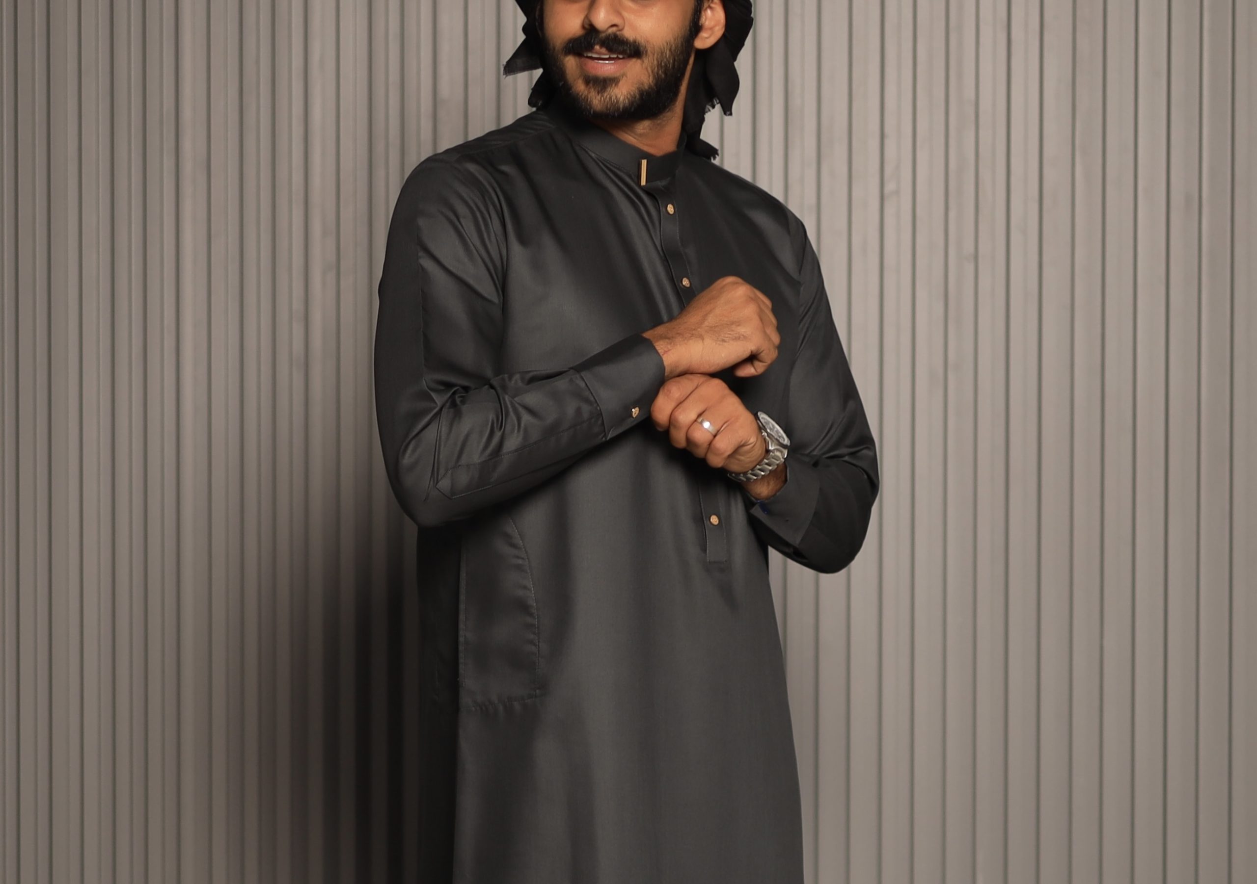 Black collar thobe with gold buttons styled with a black Yemeni shemagh scarf